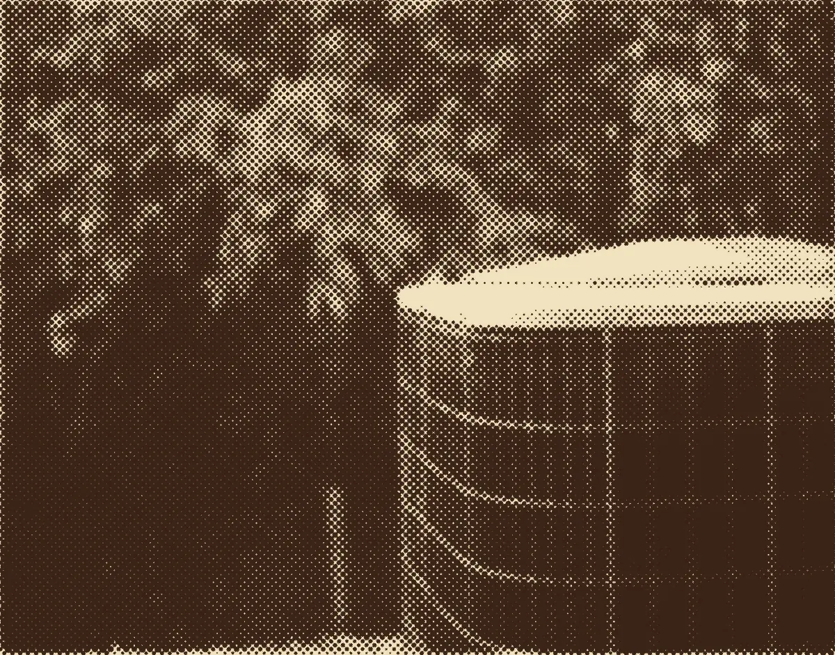 An outdoor air conditioning unit beside green trees