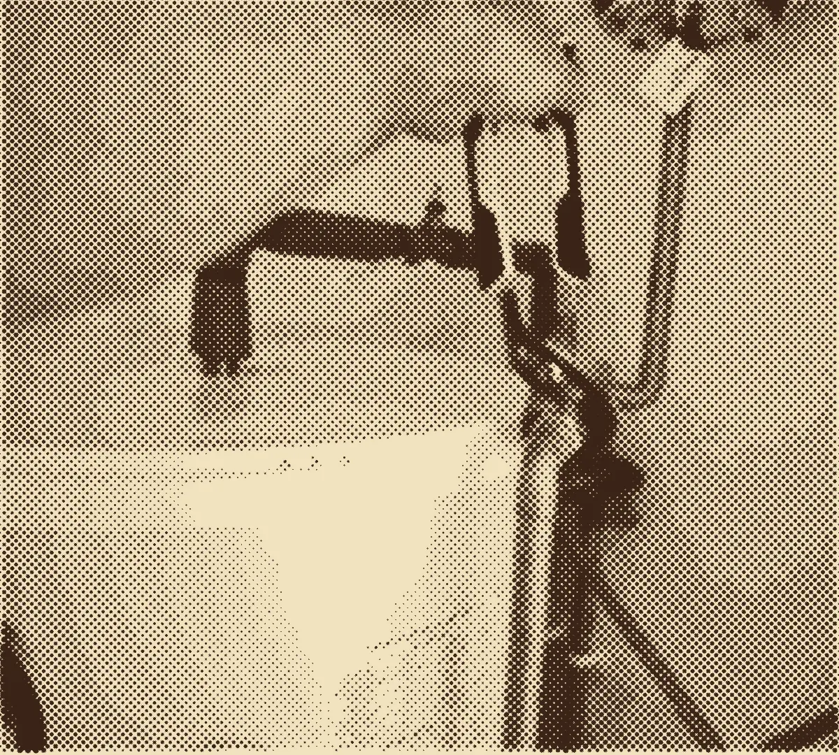 A plumber tightening a fitting on a water heater
